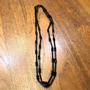 Black beaded necklace on elastic string